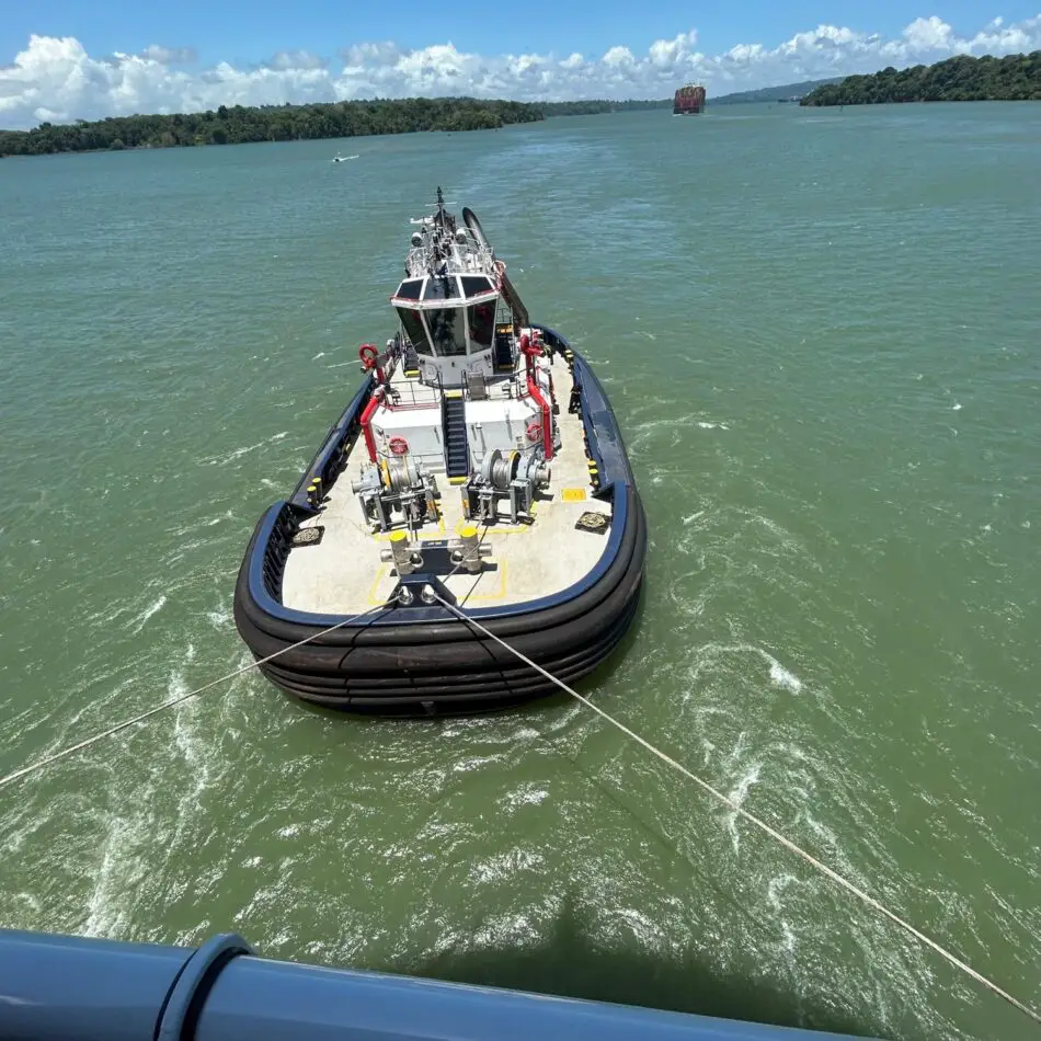 Tugboat in harbor with deck equipment photographed from a ship