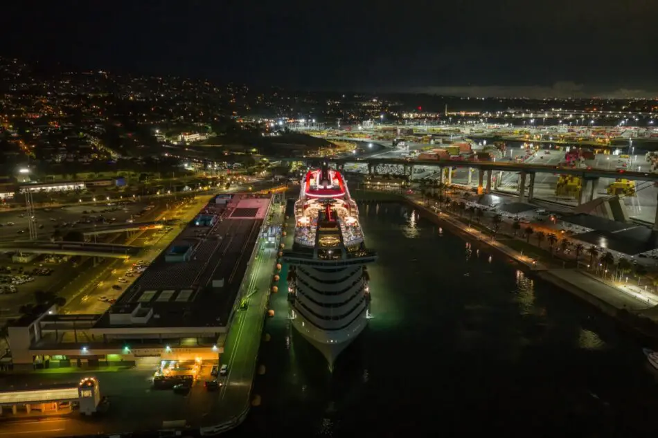 Nighttime aerial view of a large cruise ship docked at a port
