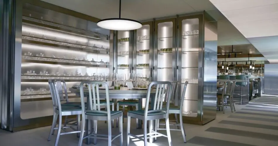 Dining area on a Virgin Voyages cruise ship with glassware display