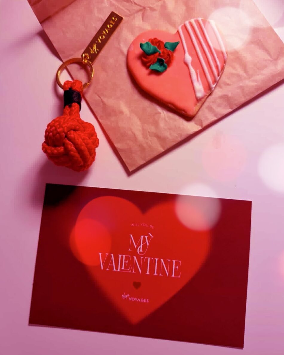 Valentine gift including heart cookie, card, and red rope keychain aboard Virgin Voyages