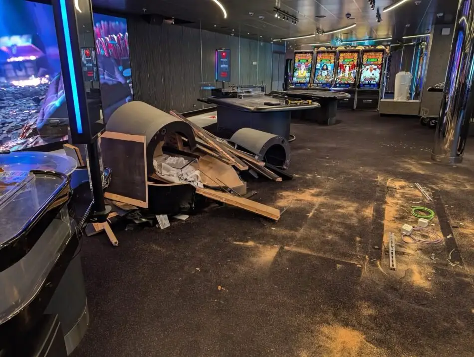 Cruise ship casino with slot machines visible in the back and construction debris on the floor