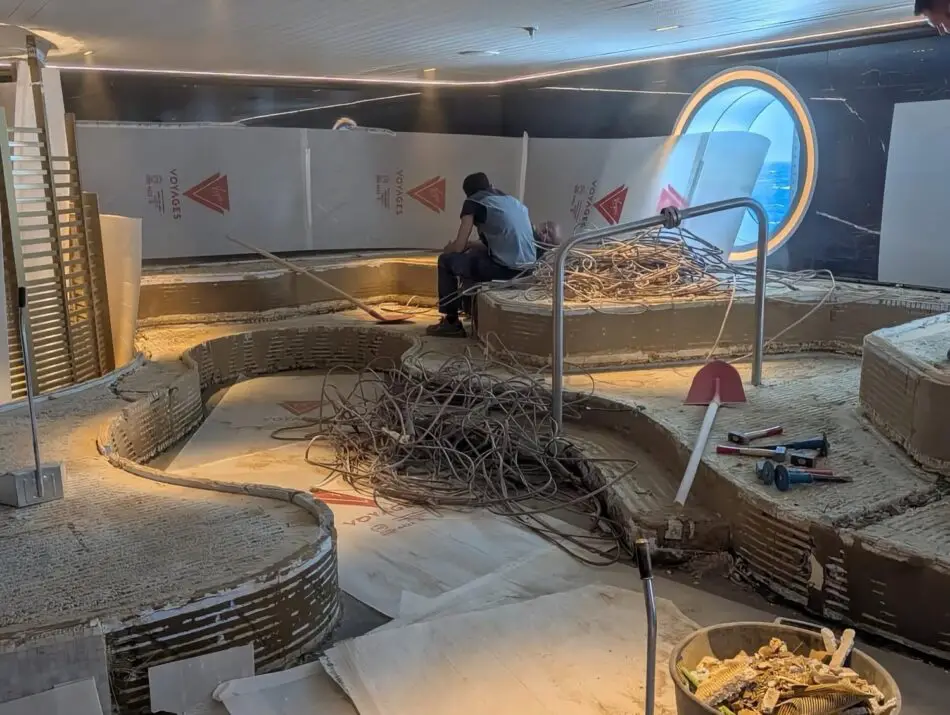 Construction work inside a Virgin Voyages cruise ship cabin with tangled cables