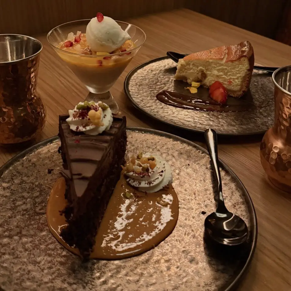 Dessert platter with chocolate cake, cheesecake, and ice cream