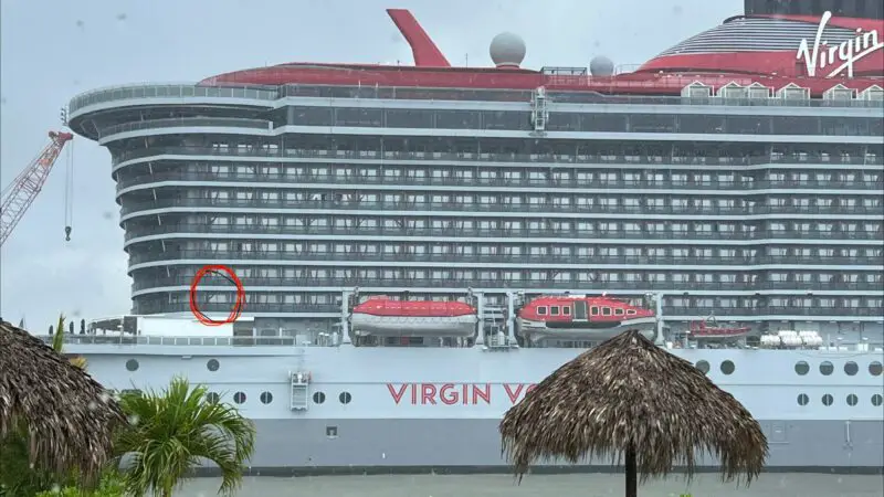 Exterior view of a Virgin Voyages cruise ship with multiple stateroom balconies visible.