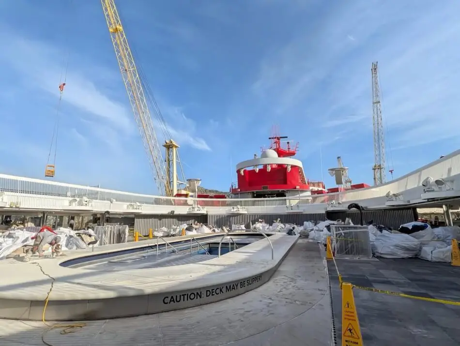 Cruise ship deck at a shipyard under construction with cranes