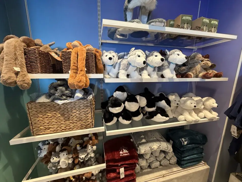 Shelves of plush animals and blankets in a gift shop