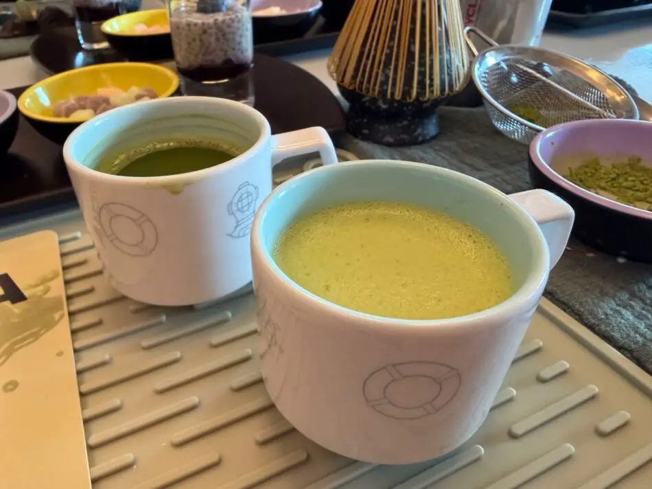 Two green drinks in lifebuoy mugs on a Virgin Voyages cruise ship cabin breakfast tray