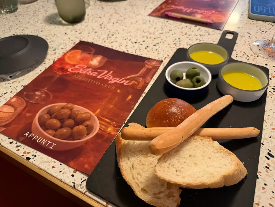 Bread slices with olives and olive oil on a tasting board