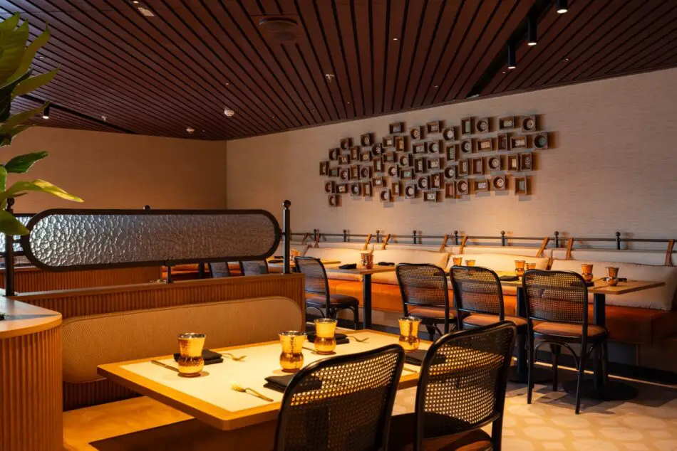 Cozy upscale restaurant dining area with wooden ceiling and amber glassware