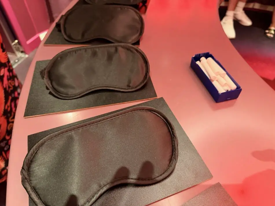 Blindfolds on a pink table on a Virgin Voyages cruise ship