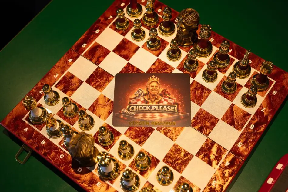 Gold chessboard with ornate pieces and a Virgin Records card reading CHECK, PLEASE!