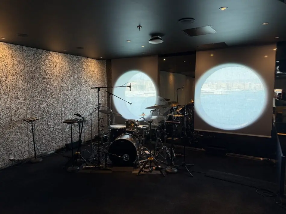 Drum kit and microphones in a Virgin Voyages cruise ship rehearsal room