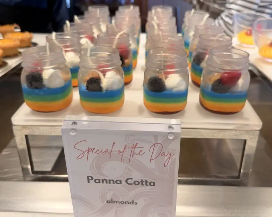 Rainbow panna cotta desserts in glass jars on a dessert buffet