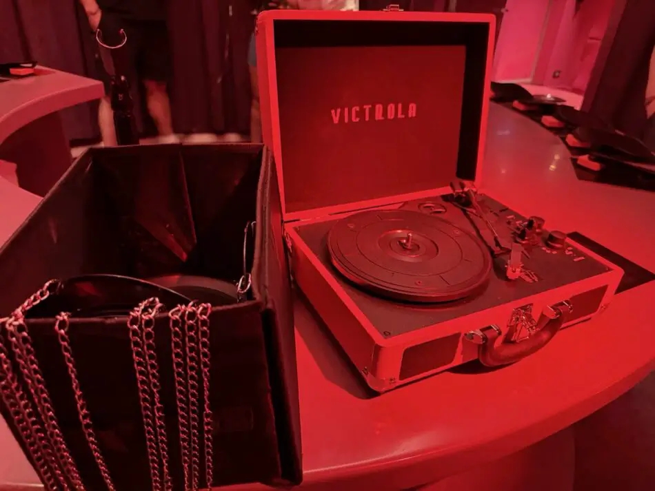 Red-lit room with an open Victrola turntable case on a table