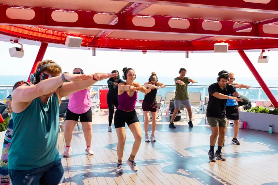 Group fitness class on a Virgin Voyages cruise ship deck