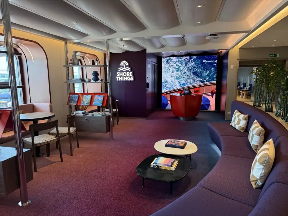 Shore Things lounge on a Virgin Voyages cruise ship with purple seating and an ocean wave screen