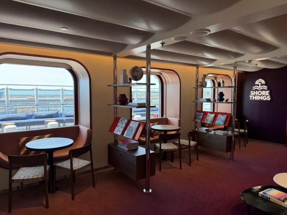 Lounge area inside a Virgin Voyages cruise ship cabin featuring Shore Things branding