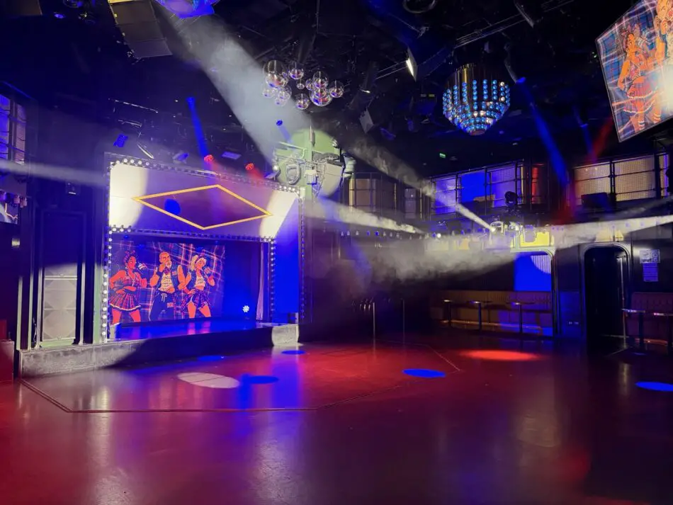 Club stage with LED panels and colorful lighting on a Virgin Voyages cruise ship