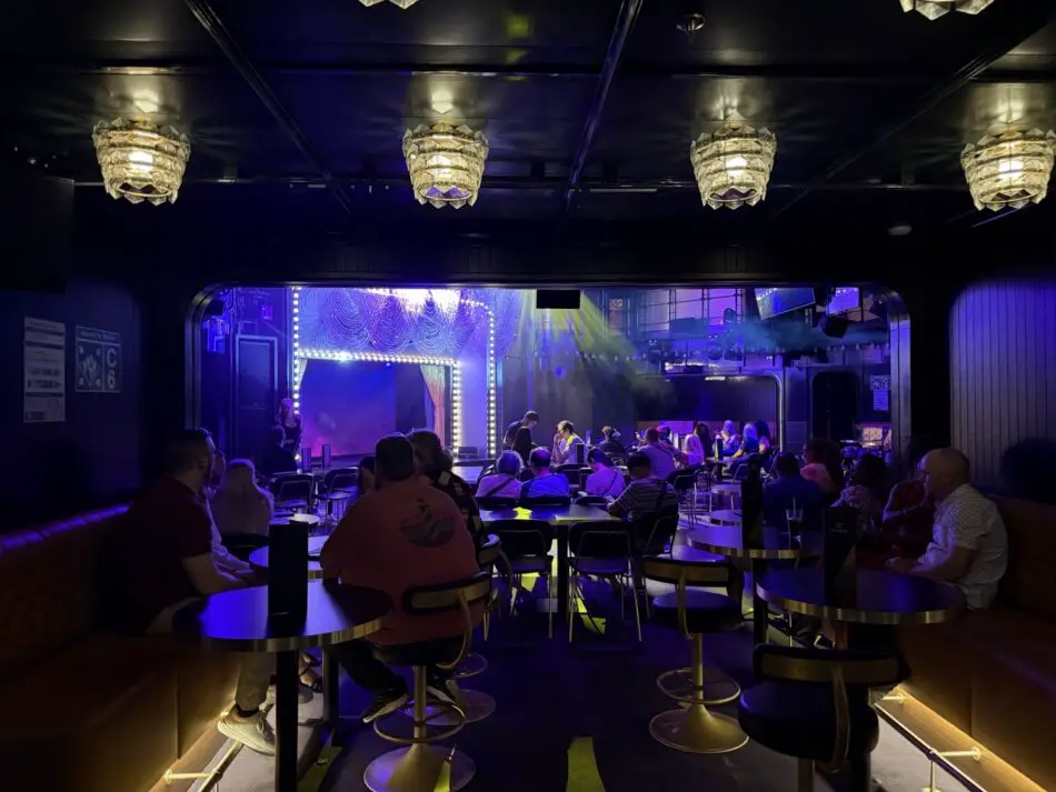 Cruise ship nightclub interior with a lit stage and audience