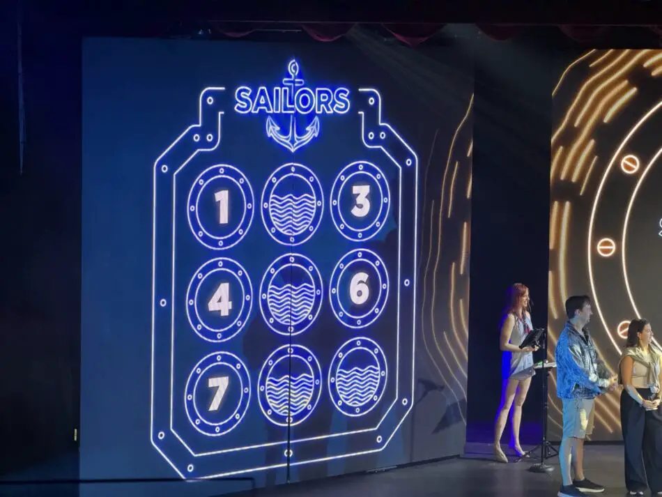 Blue neon stage backdrop with Sailors sign and circular numbered panels