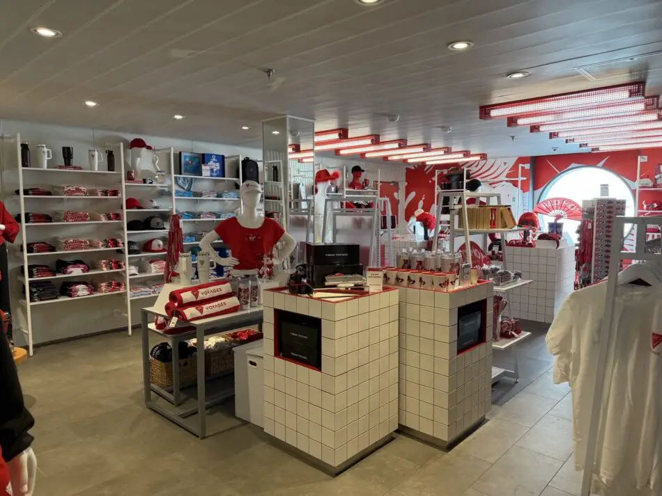 Virgin Voyages merchandise shop aboard a cruise ship with red and white decor