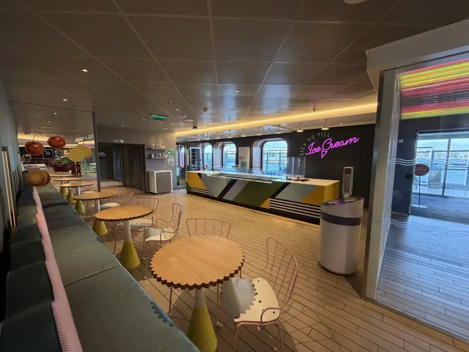 Colorful ice cream counter and seating aboard a Virgin Voyages cruise ship