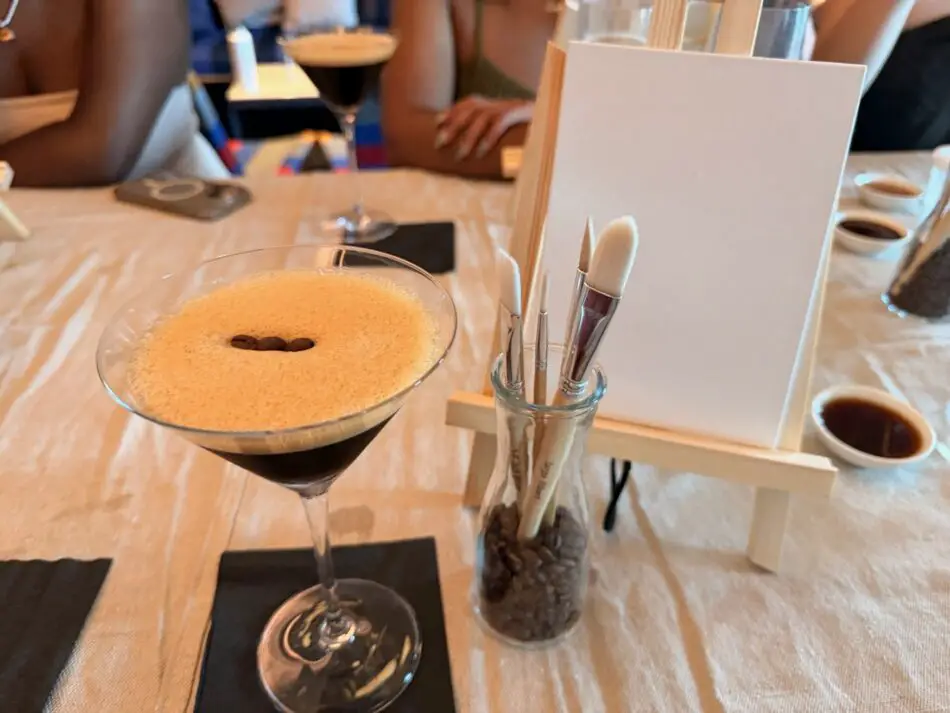 Cocktail with paintbrushes on a Virgin Voyages cruise ship table