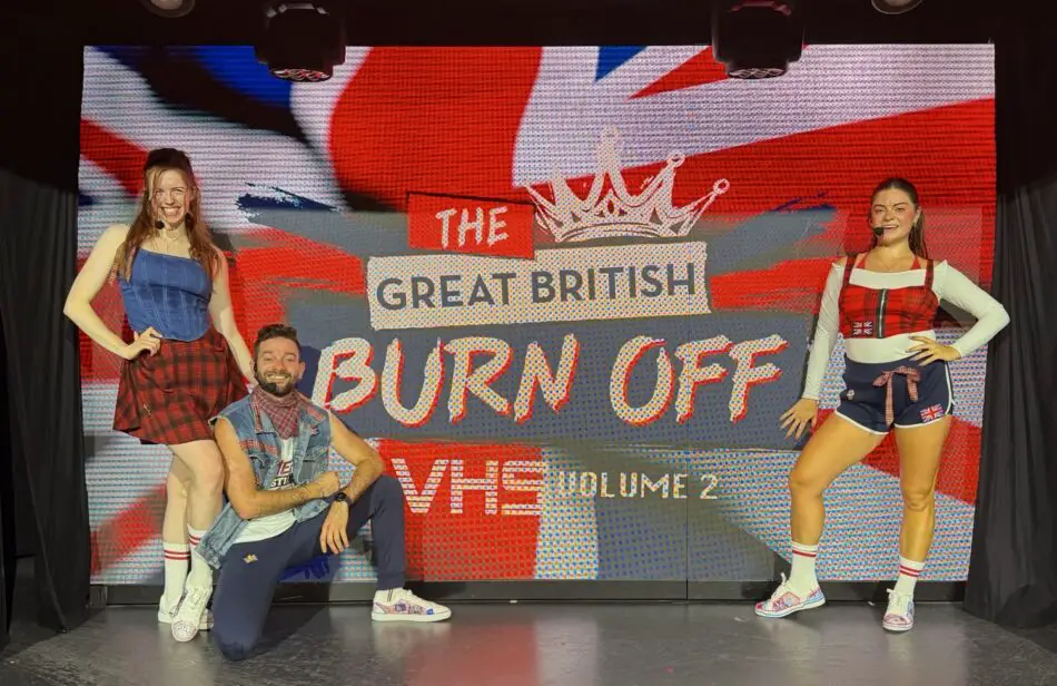 Three performers pose on stage in front of a screen reading The Great British Burn Off