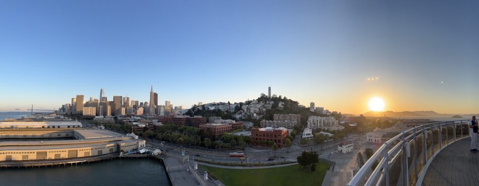 Panoramic view of the San Francisco skyline at sunset from a waterfront deck