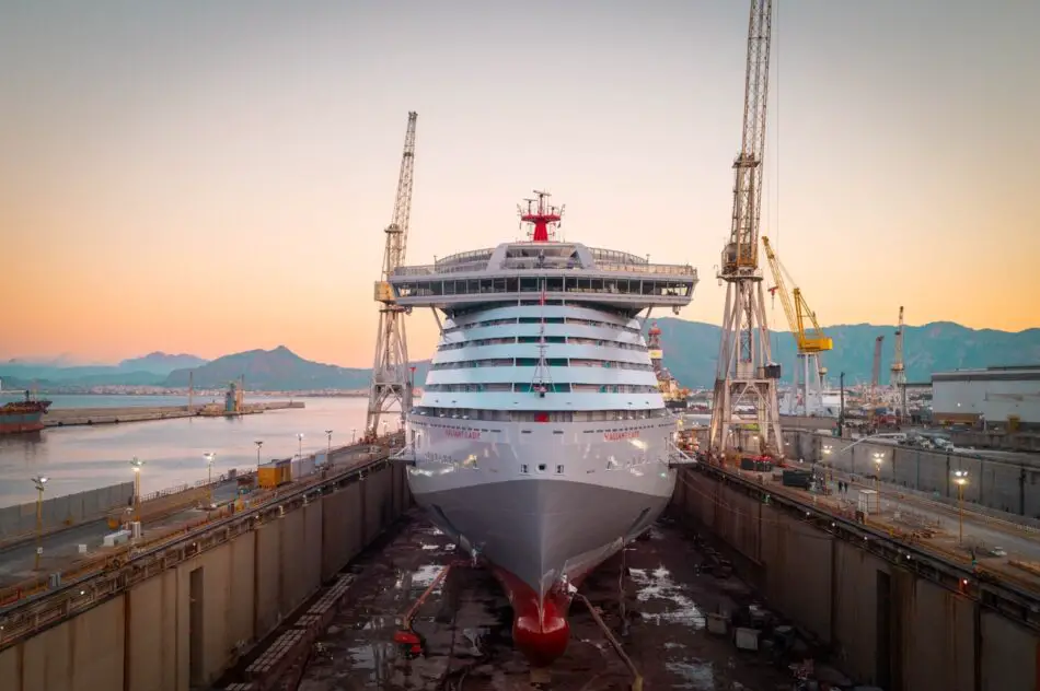 Valiant Lady in dry dock at sunset on a Virgin Voyages cruise ship