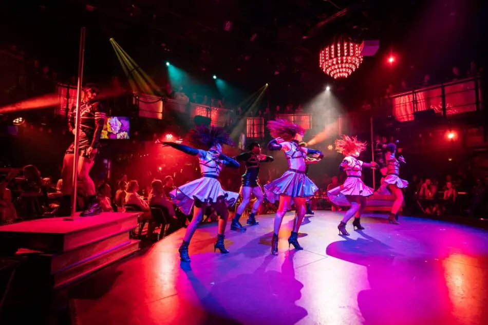 Dancers perform a high-energy routine aboard a Virgin Voyages cruise ship
