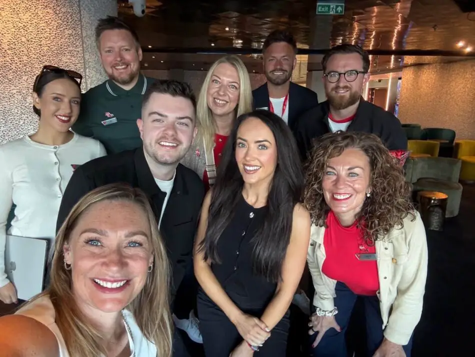 Group of people posing for a selfie on a Virgin Voyages cruise ship