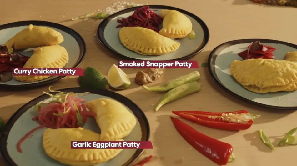 Assorted patties labeled Curry Chicken Patty, Smoked Snapper Patty, and Garlic Eggplant Patty on plates