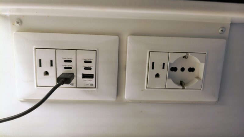 Wall outlets and USB ports in a Virgin Voyages cruise ship cabin.