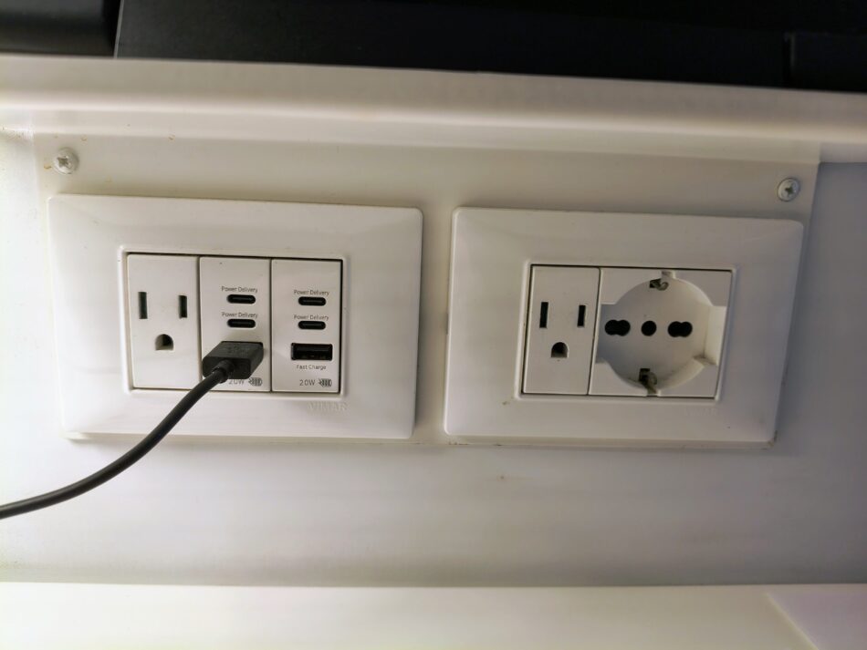 Wall outlets and USB ports in a Virgin Voyages cruise ship cabin.