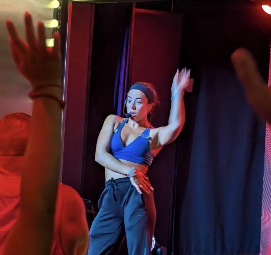 Stage performer in blue sports bra with headset