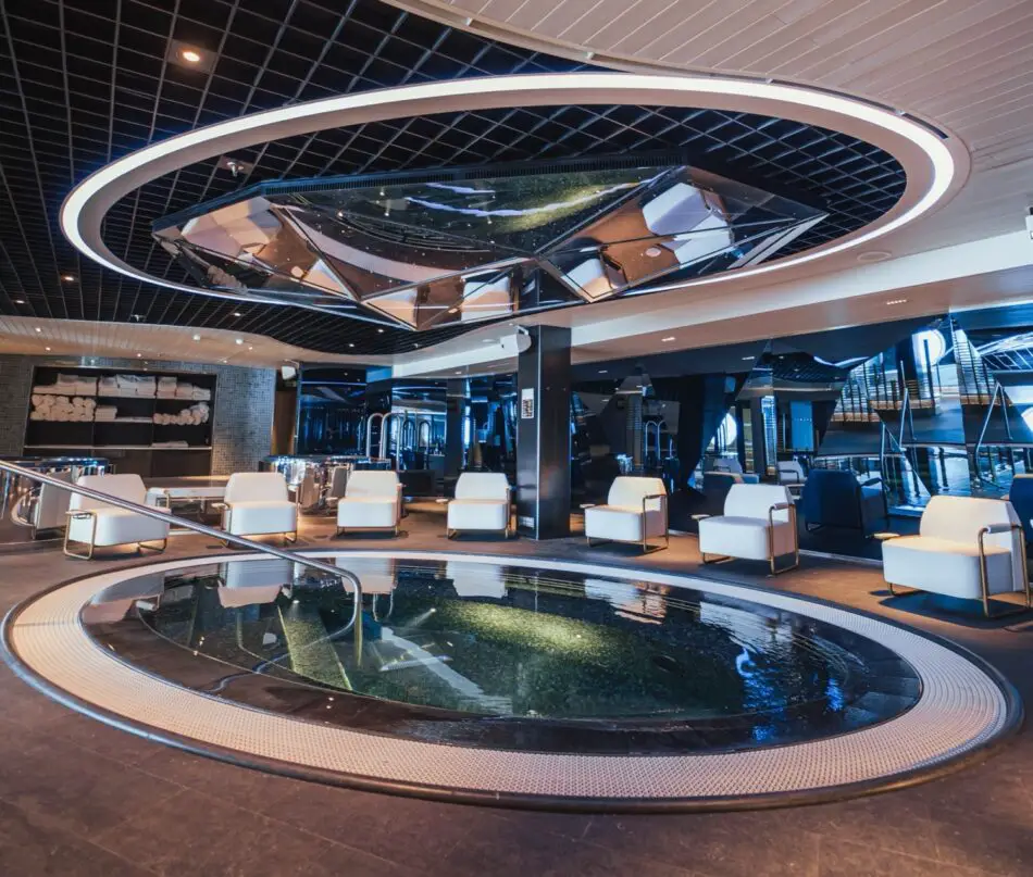 Luxurious cruise ship lounge with a circular illuminated ceiling ring and pool