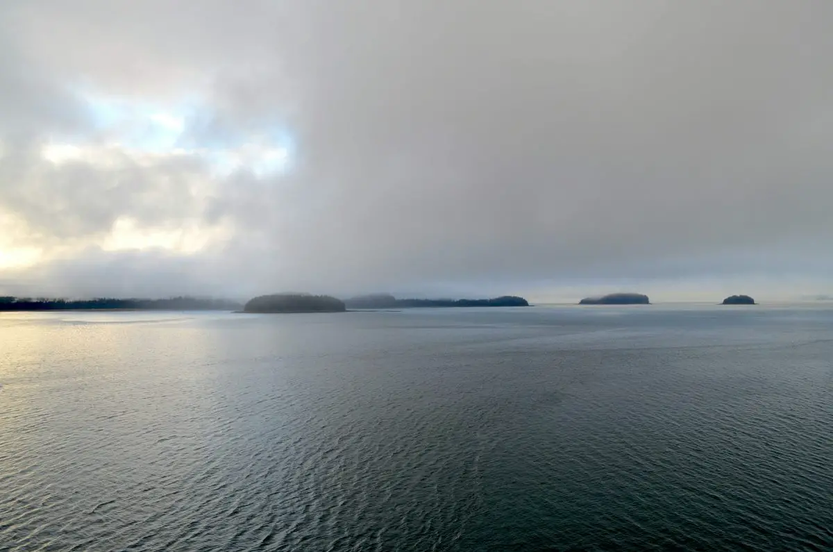 Calm water and forested islands at Icy Strait, Alaska.