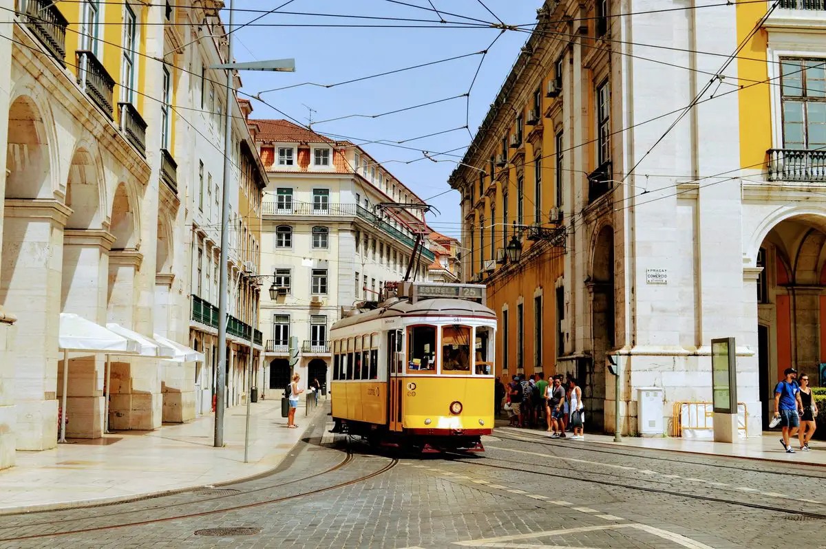 Yellow tram on a historic street in Lisbon, Portugal