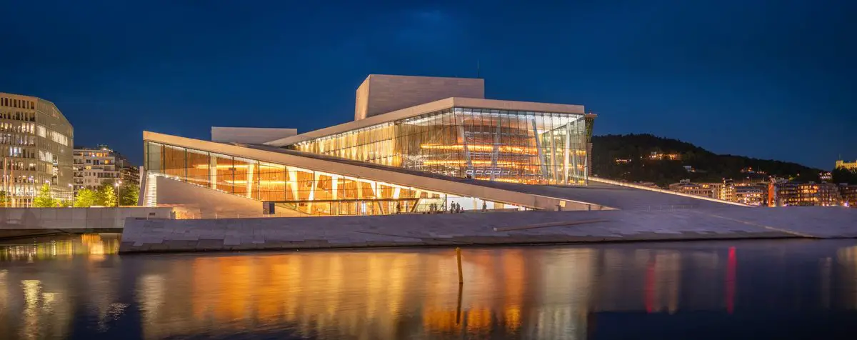 Oslo Opera House illuminated beside the water, Norway
